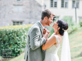 Bickley Mill Bride and groom holing hands in a close embrace at Bickley Mill