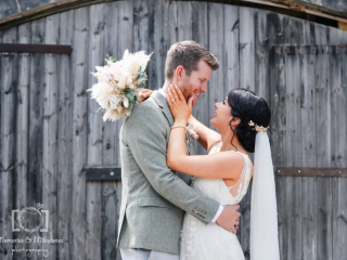 bickley mill Couple in front of rustic barn at Bickley Mill