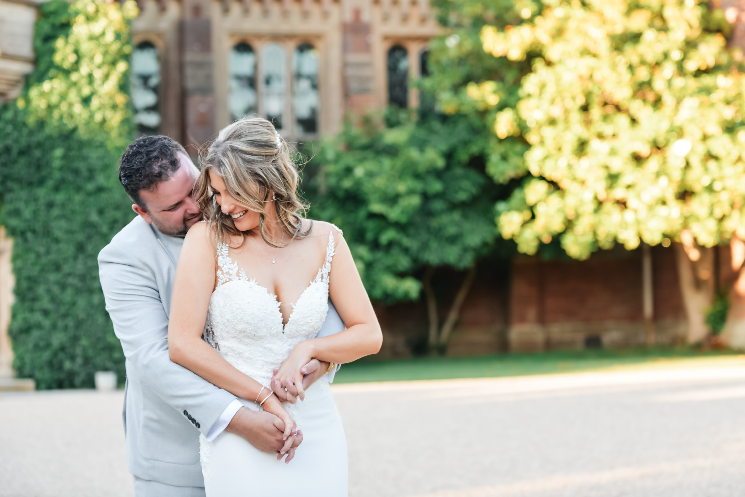 Bride and groom in an embrace outside St Audries Park taken by Memories and Milestones