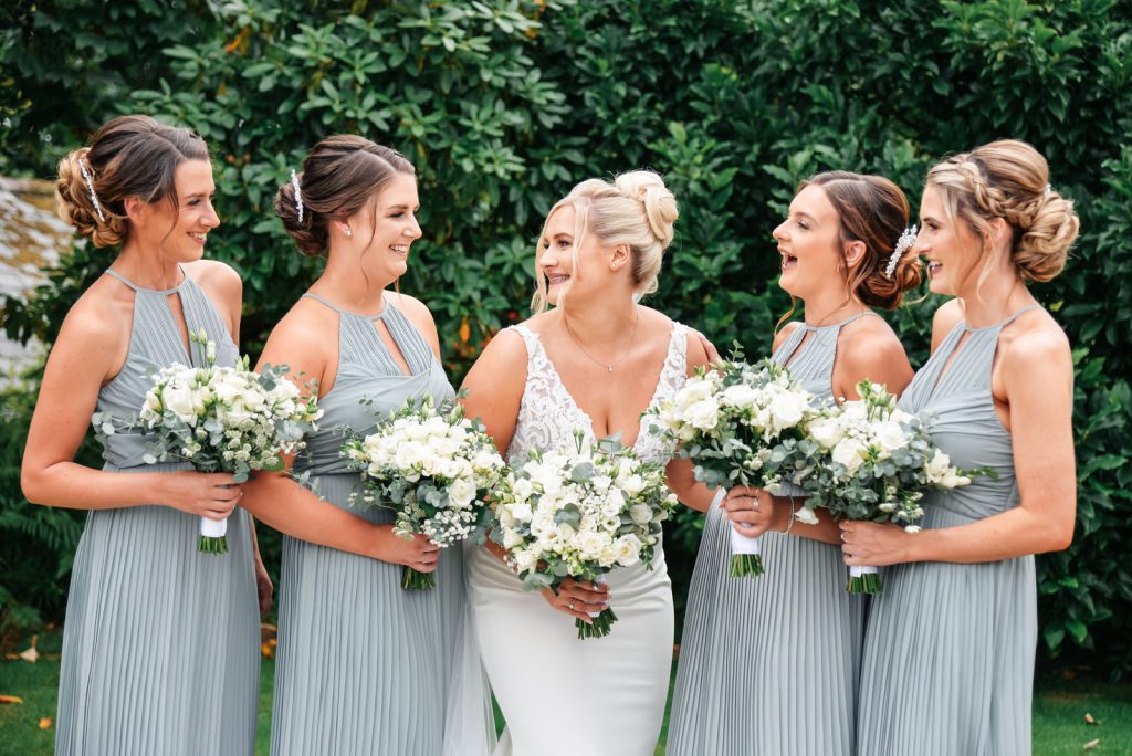 Brdie and bridesmaids smiling and laughing at The Green Cornwall captured by Memories &amp; Milestones Photography