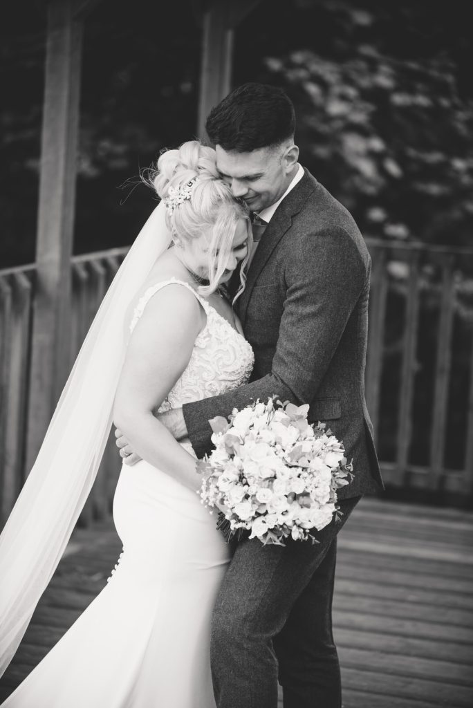 Married couple embracing at The Green Cornwall captured by Memories &amp; Milestones Photography